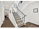 Elegant staircase with gray carpet, white walls, and stylish railing design at 12 Ivy Ne Rdg, Atlanta, GA 30342