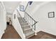 Staircase with modern metal railing and white walls at 12 Ivy Ne Rdg, Atlanta, GA 30342