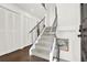 Elegant staircase with gray carpet, white walls, and stylish railing design at 12 Ivy Ne Rdg, Atlanta, GA 30342