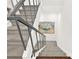 Carpeted staircase with a gray railing and a view of art on the wall at 12 Ivy Ne Rdg, Atlanta, GA 30342