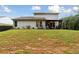 Expansive backyard with a lush lawn, a dark privacy fence, and a covered patio area with outdoor furniture at 404 Arden, Ellenwood, GA 30294