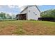Wide backyard view with a dark privacy fence, a covered patio, and generous green space at 404 Arden, Ellenwood, GA 30294