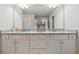 Bathroom vanity featuring double sinks with granite countertops and white cabinets offering ample storage space at 404 Arden, Ellenwood, GA 30294