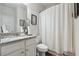 Cozy bathroom with granite counters, toilet, and tub/shower combination featuring a white curtain at 404 Arden, Ellenwood, GA 30294
