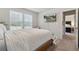 Bedroom with a wood bed frame, white bedding, and a mounted TV, with a view into another bedroom at 404 Arden, Ellenwood, GA 30294