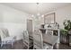 Bright dining room features modern chandelier, neutral paint, and lovely accent furniture at 404 Arden, Ellenwood, GA 30294