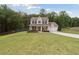 Beautiful two-story home with a covered front porch, attached garage, and expansive grassy front yard at 404 Arden, Ellenwood, GA 30294
