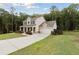 Stately two-story home with a columned front porch, attached garage, and a well-manicured lawn at 404 Arden, Ellenwood, GA 30294