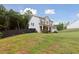 Charming two-story house featuring a covered porch, well-maintained lawn, and private yard at 404 Arden, Ellenwood, GA 30294