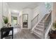 Grand foyer with hardwood floors, staircase, and view to the entry door and backyard at 404 Arden, Ellenwood, GA 30294