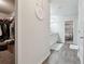 Hallway with hardwood floors leading to a walk-in closet, bathroom vanity, and the main bedroom at 404 Arden, Ellenwood, GA 30294