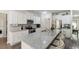 Bright kitchen with white cabinets, stainless appliances, granite countertops and a large central island at 404 Arden, Ellenwood, GA 30294