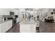 Beautiful kitchen with white cabinetry, stainless appliances, granite counters, and a large island with seating at 404 Arden, Ellenwood, GA 30294