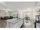 Open concept kitchen with granite island, stainless appliances, and view to living and dining area at 404 Arden, Ellenwood, GA 30294