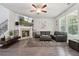 Comfortable living room with fireplace, large windows, and leather sectional, perfect for relaxation at 404 Arden, Ellenwood, GA 30294