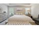 Calm primary bedroom features an upholstered bench, accent pillows, and natural light at 404 Arden, Ellenwood, GA 30294