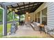 Cozy covered patio with comfortable seating, a grill, heater and a ceiling fan, perfect for outdoor entertaining at 404 Arden, Ellenwood, GA 30294