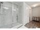 Modern glass-enclosed shower with marble-look tile surround, providing a sleek and luxurious bathing experience at 404 Arden, Ellenwood, GA 30294