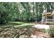 Beautifully landscaped backyard featuring a seating area and covered porch at 437 Valley Brook Ne Dr, Atlanta, GA 30342