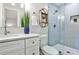 Modern bathroom featuring blue subway tile shower, white vanity, and stylish fixtures at 437 Valley Brook Ne Dr, Atlanta, GA 30342