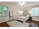 Cozy bedroom with hardwood floors, ceiling fan, two windows, and stylish furnishings at 437 Valley Brook Ne Dr, Atlanta, GA 30342