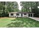 Charming brick home with manicured lawn, blue front door, and a convenient porte cochere at 437 Valley Brook Ne Dr, Atlanta, GA 30342