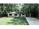 Charming brick home with manicured lawn, blue front door, and a convenient porte cochere at 437 Valley Brook Ne Dr, Atlanta, GA 30342