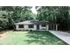 Charming brick home with manicured lawn, blue front door, and a convenient porte cochere at 437 Valley Brook Ne Dr, Atlanta, GA 30342