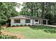 Charming brick home with manicured lawn, blue front door, and a convenient porte cochere at 437 Valley Brook Ne Dr, Atlanta, GA 30342