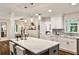 Bright, open kitchen featuring white cabinets, marble countertops, and a large island with pendant lighting at 437 Valley Brook Ne Dr, Atlanta, GA 30342