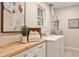 Convenient laundry room with modern washer and dryer, butcher block counter, and storage cabinets at 437 Valley Brook Ne Dr, Atlanta, GA 30342
