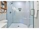 Elegant walk-in shower with blue tiling, glass door, and built-in seating at 437 Valley Brook Ne Dr, Atlanta, GA 30342