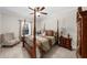 Cozy bedroom featuring four-poster bed, soft natural light, and matching furniture at 4425 Martel Dr, Cumming, GA 30040