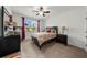 Cozy bedroom with neutral tones, ceiling fan, and a view of the outdoors at 4425 Martel Dr, Cumming, GA 30040