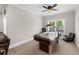 Bright game room featuring an air hockey table, comfortable chair, and outdoor views at 4425 Martel Dr, Cumming, GA 30040