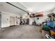 Well-lit garage featuring a large open area with overhead storage and a side service door at 4425 Martel Dr, Cumming, GA 30040