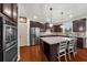 Modern kitchen with stainless steel appliances, granite countertops, a center island and hardwood floors at 4425 Martel Dr, Cumming, GA 30040