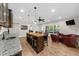 Open-concept living area with wet bar, island seating, granite counters, and backyard access at 4425 Martel Dr, Cumming, GA 30040
