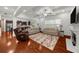 Open living room boasts hardwood floors, coffered ceiling, and fireplace, ideal for relaxation at 4425 Martel Dr, Cumming, GA 30040