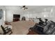 Spacious, carpeted living room featuring a ceiling fan, railing and comfortable seating at 4425 Martel Dr, Cumming, GA 30040