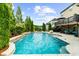 A sparkling pool and landscaping in backyard with a covered patio and outdoor seating area at 4425 Martel Dr, Cumming, GA 30040