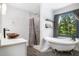 This elegant bathroom features a freestanding tub, a bowl sink, a marble shower, and wood-look floors at 2085 Castle Royale Dr, Lawrenceville, GA 30043