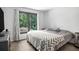 This cozy bedroom has a large window overlooking greenery, soft carpet, and simple furnishings at 2085 Castle Royale Dr, Lawrenceville, GA 30043