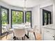 Cozy breakfast nook with views of the in-ground pool, a stained-glass window, a modern chandelier and hardwood floors at 2085 Castle Royale Dr, Lawrenceville, GA 30043