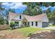 Charming home with a well-maintained lawn, stone accents, a gray two-car garage and lush landscaping at 2085 Castle Royale Dr, Lawrenceville, GA 30043