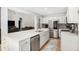Bright kitchen featuring stainless steel appliances, quartz countertops and a view to the living room at 2085 Castle Royale Dr, Lawrenceville, GA 30043