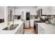 Bright kitchen with stainless steel appliances, quartz countertops, stylish tile backsplash, and hardwood floors at 2085 Castle Royale Dr, Lawrenceville, GA 30043