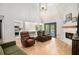 Comfortable living room with hardwood floors, fireplace and an open layout to the kitchen and breakfast nook at 2085 Castle Royale Dr, Lawrenceville, GA 30043