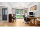 Sunlit living room features hardwood floors, tray ceiling, and large windows offering views of the well-manicured lawn at 2085 Castle Royale Dr, Lawrenceville, GA 30043