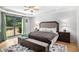 This spacious main bedroom features a large window with a view and a tray ceiling with a ceiling fan at 2085 Castle Royale Dr, Lawrenceville, GA 30043